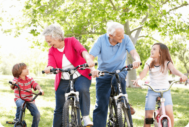 Family across generations riding bikes together